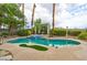 Inviting backyard pool and spa with a covered lounge area, surrounded by lush landscaping and mature trees at 1704 River Birch St, Las Vegas, NV 89117