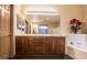 Bathroom with a double sink vanity, a large mirror, wood floors, and a soaking tub with tile at 1808 Peyton Stewart Ct, North Las Vegas, NV 89086
