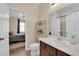 Bright bathroom featuring a vanity sink, adjacent toilet, and an open doorway to the bedroom at 1808 Peyton Stewart Ct, North Las Vegas, NV 89086