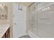 Bathroom featuring a white door with an over the door rack, and a glass enclosed bathtub with shower at 1808 Peyton Stewart Ct, North Las Vegas, NV 89086
