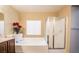 Bathroom with a soaking tub, glass enclosed shower, and a vanity with a white countertop at 1808 Peyton Stewart Ct, North Las Vegas, NV 89086