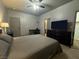 Bedroom with a bed, dresser with a TV, a ceiling fan, and a desk with a chair at 1808 Peyton Stewart Ct, North Las Vegas, NV 89086