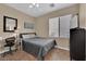 Comfortable bedroom features a ceiling fan, window, desk, and tile flooring at 1808 Peyton Stewart Ct, North Las Vegas, NV 89086