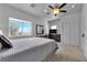 Spacious bedroom with a large window, ceiling fan, and closet for ample storage at 1808 Peyton Stewart Ct, North Las Vegas, NV 89086