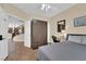 Comfortable bedroom with tile flooring, large wardrobe, desk, and view of the home at 1808 Peyton Stewart Ct, North Las Vegas, NV 89086