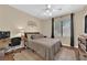 Bright bedroom with tile floors, ceiling fan, and work space at 1808 Peyton Stewart Ct, North Las Vegas, NV 89086