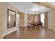 Dining area featuring tile floors, neutral walls, chandelier lighting and view to the adjacent living area at 1808 Peyton Stewart Ct, North Las Vegas, NV 89086