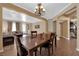 Dining area featuring tile floors, neutral walls, chandelier lighting and view to the adjacent living area at 1808 Peyton Stewart Ct, North Las Vegas, NV 89086