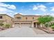 Charming two-story home featuring a three car garage, desert landscaping, and covered front entryway at 1808 Peyton Stewart Ct, North Las Vegas, NV 89086