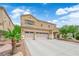 Charming two-story home featuring a three car garage, desert landscaping, and covered front entryway at 1808 Peyton Stewart Ct, North Las Vegas, NV 89086
