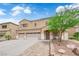 Charming two-story home featuring a three car garage, desert landscaping, and covered front entryway at 1808 Peyton Stewart Ct, North Las Vegas, NV 89086