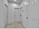 Hallway showcasing multiple neutral doors, offering access to rooms within the home at 1808 Peyton Stewart Ct, North Las Vegas, NV 89086