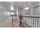 Upstairs hallway featuring an elegant chandelier, carpet, and natural light at 1808 Peyton Stewart Ct, North Las Vegas, NV 89086