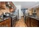 Kitchen view featuring stainless steel appliances, dark wood cabinets, and an adjacent staircase at 1808 Peyton Stewart Ct, North Las Vegas, NV 89086