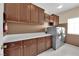Functional laundry room with upper and lower cabinets, complemented by modern washer and dryer at 1808 Peyton Stewart Ct, North Las Vegas, NV 89086