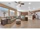 Cozy living room featuring a large sectional sofa, ceiling fan, and seamless access to the adjacent kitchen at 1808 Peyton Stewart Ct, North Las Vegas, NV 89086