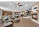 Open-concept living room with staircase, fireplace, and views of the kitchen and dining area at 1808 Peyton Stewart Ct, North Las Vegas, NV 89086