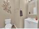 Cozy powder room featuring a modern vanity, neutral walls, and decorative accents at 1808 Peyton Stewart Ct, North Las Vegas, NV 89086