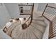 Carpeted curved staircase with decorative metal railing, leading to the lower level of the home at 1808 Peyton Stewart Ct, North Las Vegas, NV 89086