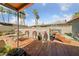 Inviting backyard deck with bar stools and tropical palm trees, perfect for outdoor entertaining and relaxation at 1916 Canosa Ave, Las Vegas, NV 89104
