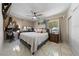 Spacious bedroom featuring a ceiling fan, tiled floors, natural light, and a sizable closet at 1916 Canosa Ave, Las Vegas, NV 89104