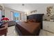 Bedroom with a large upholstered headboard and plush bedding, complemented by bright window and stylish decor at 1916 Canosa Ave, Las Vegas, NV 89104