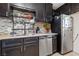Functional kitchen featuring dark cabinetry, stainless steel appliances, and sleek countertops at 1916 Canosa Ave, Las Vegas, NV 89104