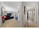 A hallway leading to a beautifully decorated living room with tile flooring, comfortable seating, and contemporary decor at 1916 Canosa Ave, Las Vegas, NV 89104
