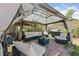 Relaxing patio area with comfortable seating under a gazebo, surrounded by lush greenery for a serene outdoor experience at 1916 Canosa Ave, Las Vegas, NV 89104