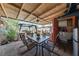Charming covered patio with a dining table and access to a laundry room, ideal for outdoor meals and relaxation at 1916 Canosa Ave, Las Vegas, NV 89104