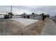 A view of the fenced backyard, with a concrete platform and updated windows at 2036 Canosa Ave, Las Vegas, NV 89104