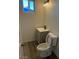 A cozy bathroom with a toilet, vanity, sink and modern light fixture above the vanity at 2036 Canosa Ave, Las Vegas, NV 89104