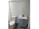 This bathroom has white toilet, grey vanity with sink, and dark faucet at 2036 Canosa Ave, Las Vegas, NV 89104