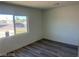 A bright bedroom featuring laminate wood flooring, a window and baseboard trim at 2036 Canosa Ave, Las Vegas, NV 89104