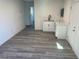A versatile living space featuring gray tone laminate flooring and a kitchenette at 2036 Canosa Ave, Las Vegas, NV 89104