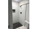 Modern shower features white subway tiles, black hardware, a built-in niche, and sleek fixtures at 2036 Canosa Ave, Las Vegas, NV 89104
