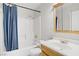 Bathroom with a shower-tub combo, blue shower curtain and vanity sink at 207 E Van Wagenen St, Henderson, NV 89015