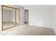 Bedroom featuring neutral carpet, a mirrored closet, and access to the hallway at 207 E Van Wagenen St, Henderson, NV 89015
