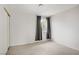 Bedroom with neutral carpet, a window with curtains, and a sliding door closet at 207 E Van Wagenen St, Henderson, NV 89015
