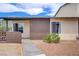 Tan single story house with brown brick accent, small bushes and palm tree in low maintenance yard at 207 E Van Wagenen St, Henderson, NV 89015