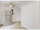 Bright kitchen features a ceiling fan, stainless steel refrigerator, and tile floors at 207 E Van Wagenen St, Henderson, NV 89015