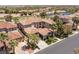 Aerial view showcases the home's tile roof, lush landscaping, and proximity to the neighborhood lake and golf course at 2436 Grassy Spring Pl, Las Vegas, NV 89135
