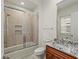 Bathroom featuring a glass-enclosed shower and granite counters at 2436 Grassy Spring Pl, Las Vegas, NV 89135