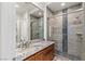 Bathroom featuring granite counters and glass-enclosed shower with decorative stone accents at 2436 Grassy Spring Pl, Las Vegas, NV 89135