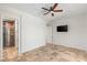 Spacious bedroom featuring travertine floors, ceiling fan, and ensuite bathroom with designer shower at 2436 Grassy Spring Pl, Las Vegas, NV 89135