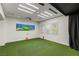 Bonus room with a golf simulator and three windows at 2436 Grassy Spring Pl, Las Vegas, NV 89135