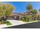 Attractive stucco home with a spacious three-car garage and well-maintained front yard at 2436 Grassy Spring Pl, Las Vegas, NV 89135