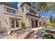 Spacious home exterior features an outdoor kitchen and a pool with a spa with views of mature landscaping at 2436 Grassy Spring Pl, Las Vegas, NV 89135
