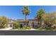 Charming home with lush landscaping and mature palm trees in a sunny, vibrant neighborhood at 2436 Grassy Spring Pl, Las Vegas, NV 89135