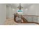 Elegant foyer featuring ornate chandelier, and wrought iron staircase, providing a luxurious ambiance at 2436 Grassy Spring Pl, Las Vegas, NV 89135